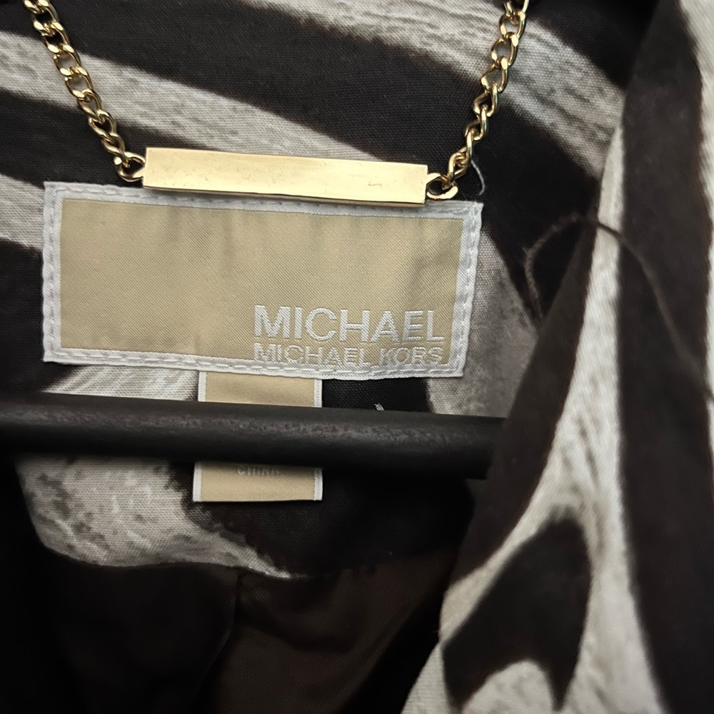 Michael Kors Woman’s Trench coat. With zebra print and with metal studs.